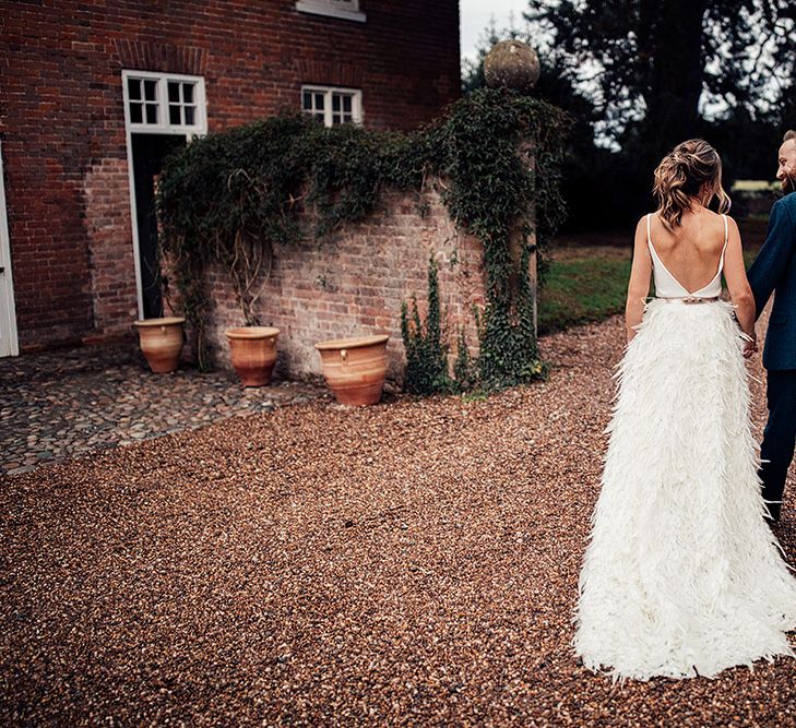 Bride in a Charlie Brear Payton Bridal Gown &amp; Piora Feather Skirt and Groom in a Wool Suit