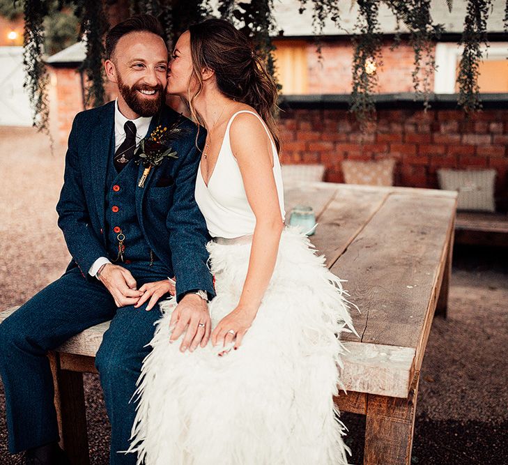 Bride in a Charlie Brear Payton Bridal Gown &amp; Piora Feather Skirt and Groom in a Navy Suit