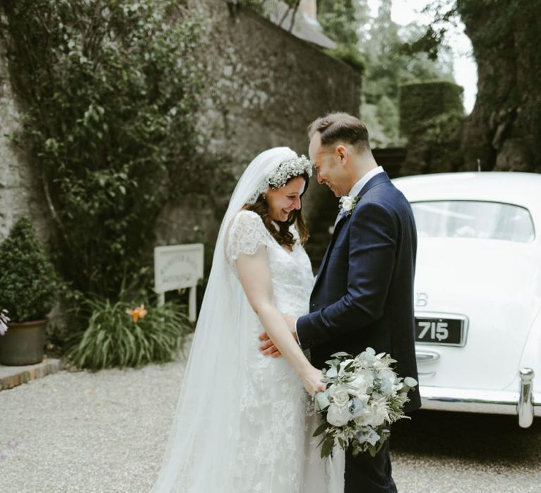 Bride in lace wedding dress with flower crown at Ramster Hall wedding