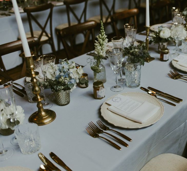 Wedding breakfast table decor with flowers and gold candlesticks