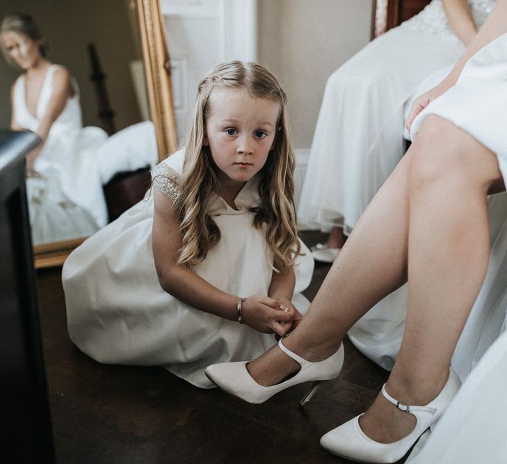 Flower Girl Helping The Bride Put On Her John Lewis Shoes