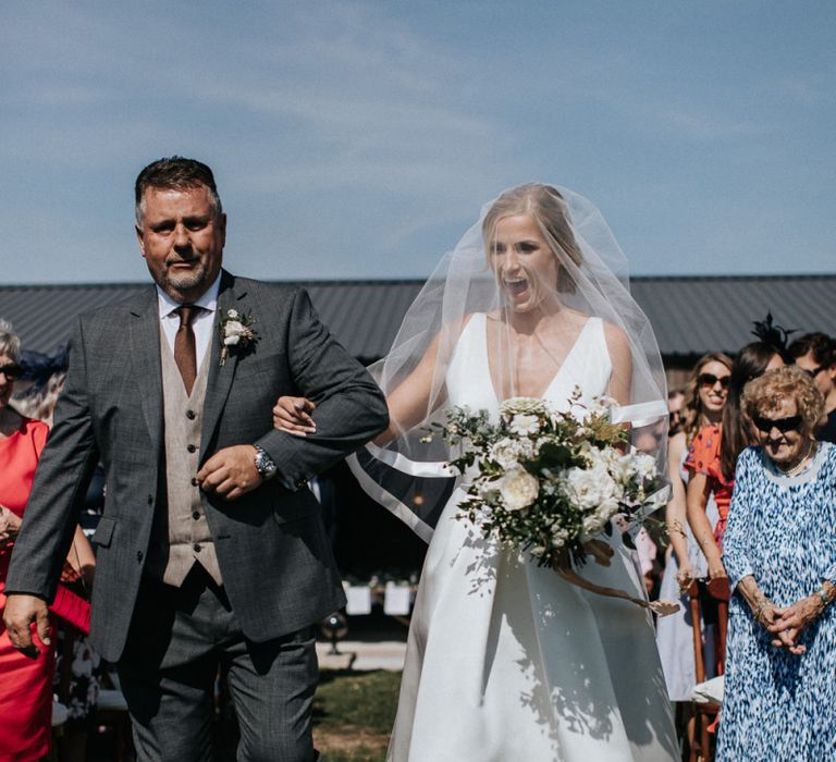 Bride Walking Down the Aisle in a Jesus Peiro Wedding Dress and Veil