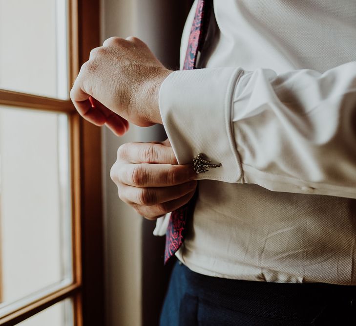 Groom Doing His Cufflinks on the Wedding Morning