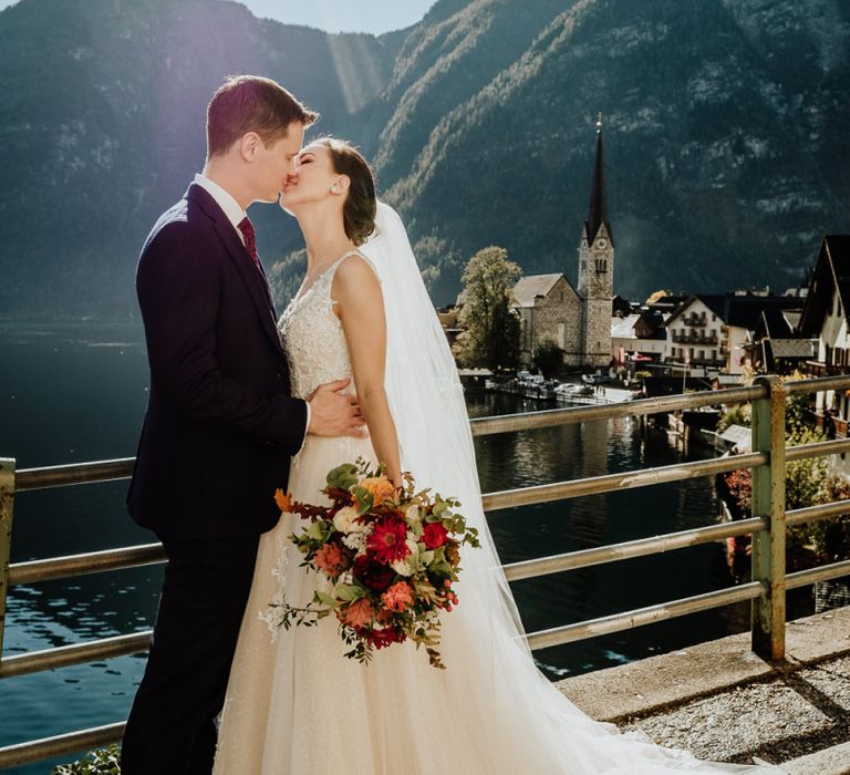 Bride and Groom Kissing with Hallstatt, Austria Scenery in the Background