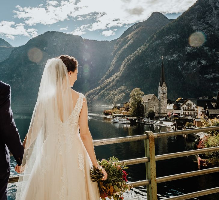 Bride and Groom Kissing with Hallstatt, Austria Scenery in the Background