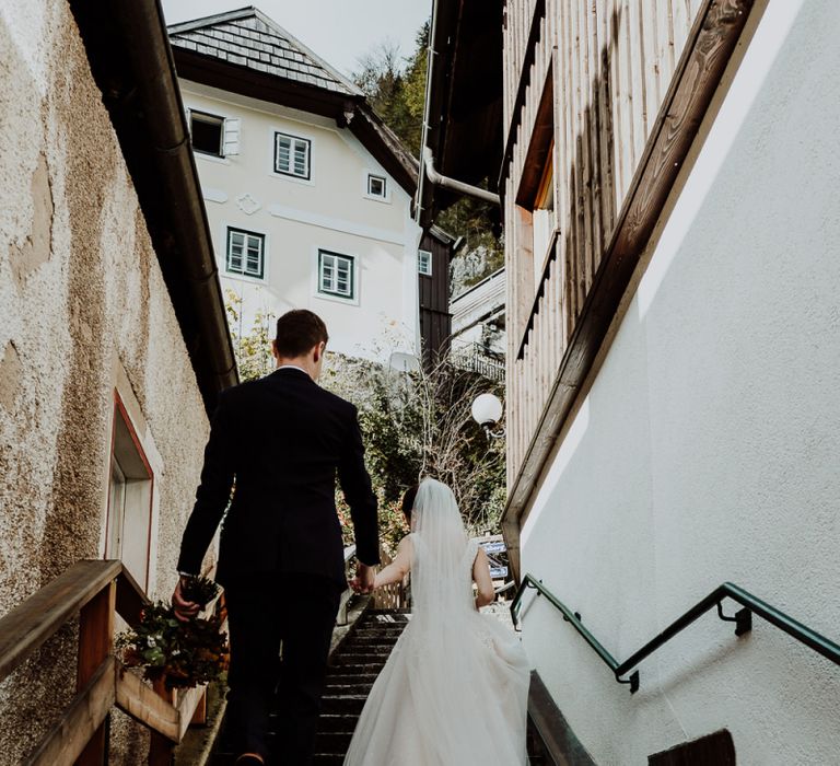 Bride and Groom Walking Up the Steps in Hallstatt, Austria