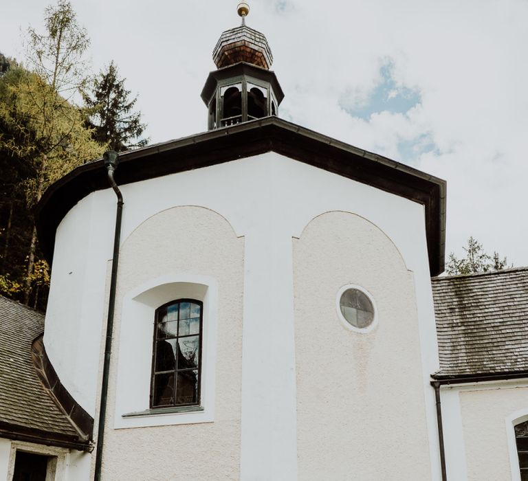 Bride and Groom Standing by The Wall of a Church in Hallstatt, Austria