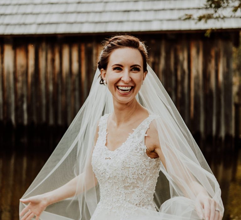 Happy Bride Twirling in Her Wedding Dress and Veil