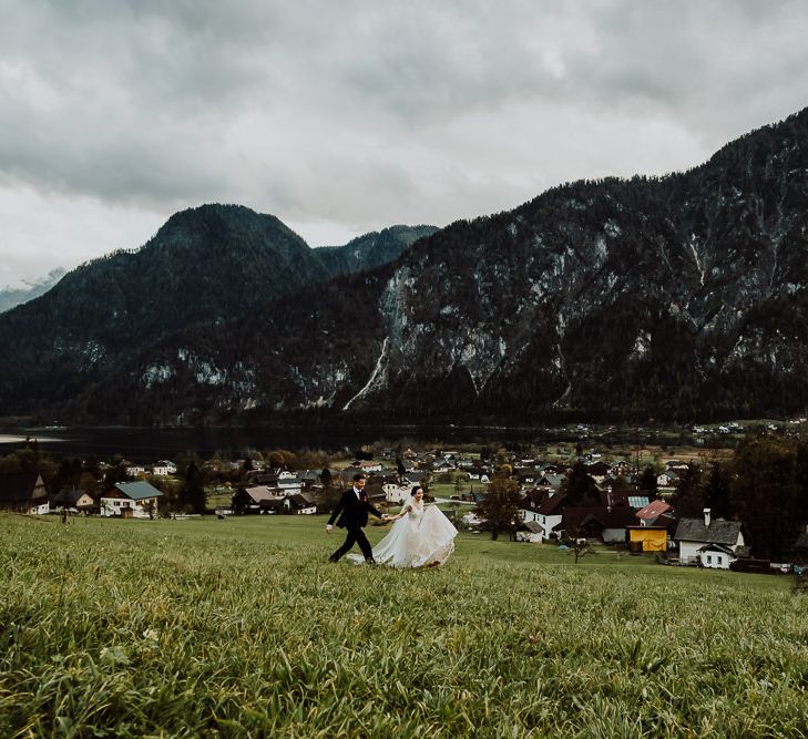 Bride and Groom Walking Along the Hillside in Hallstatt, Austria