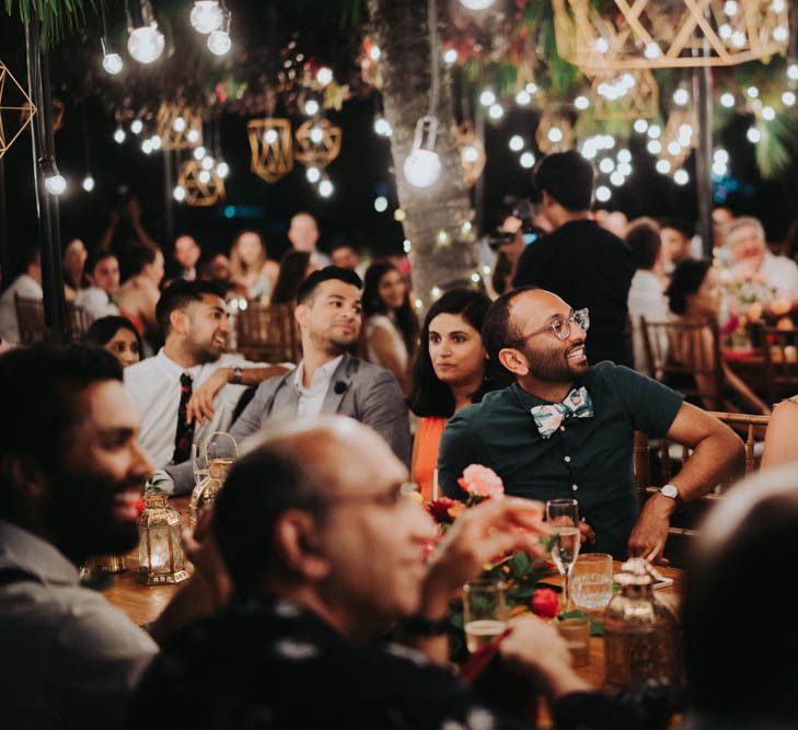 Guests enjoy speeches under light installation