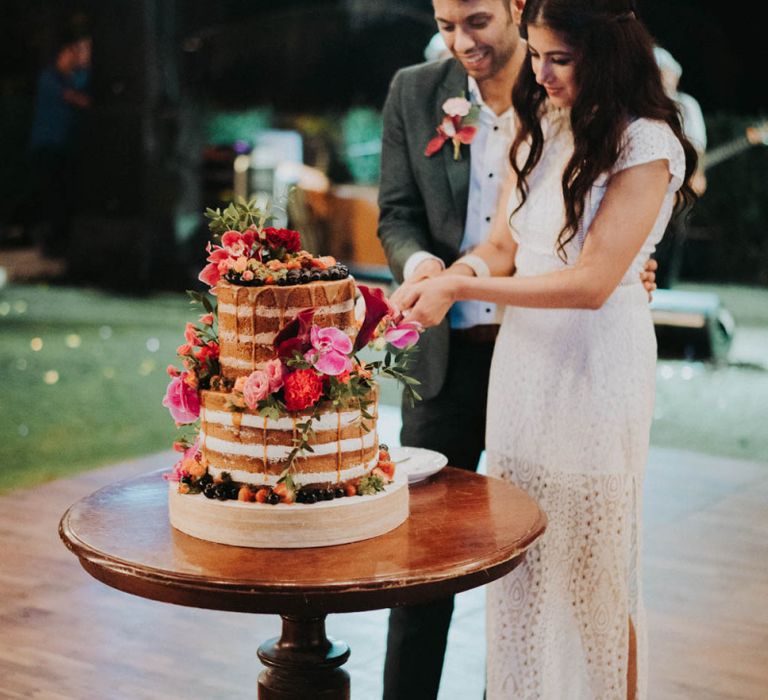 Bride and groom cut their naked wedding cake