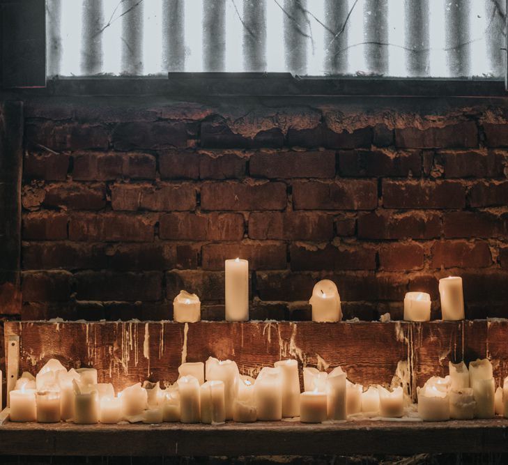 Pillar candles for cosy winter barn ceremony