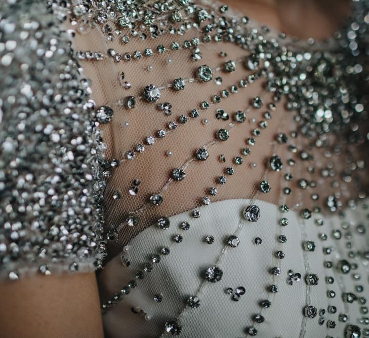 Close up details of brides embellished wedding dress for black tie New Years eve wedding with sparkles and glamour