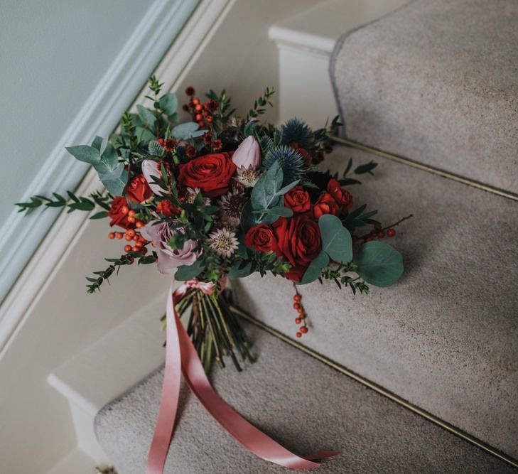 Red festive themed floral bouquet for winter wedding