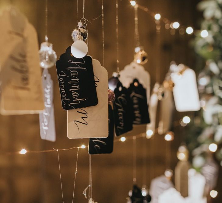 DIY table plan with baubles and fairy lights at winter reception