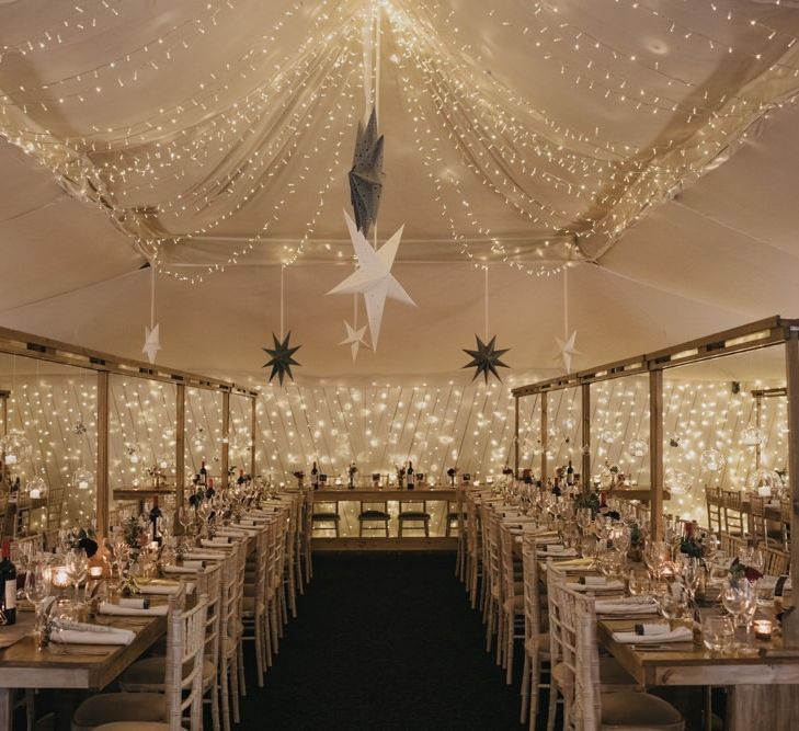 Marquee winter reception styling with star decor and fairy lights for New Years eve celebration