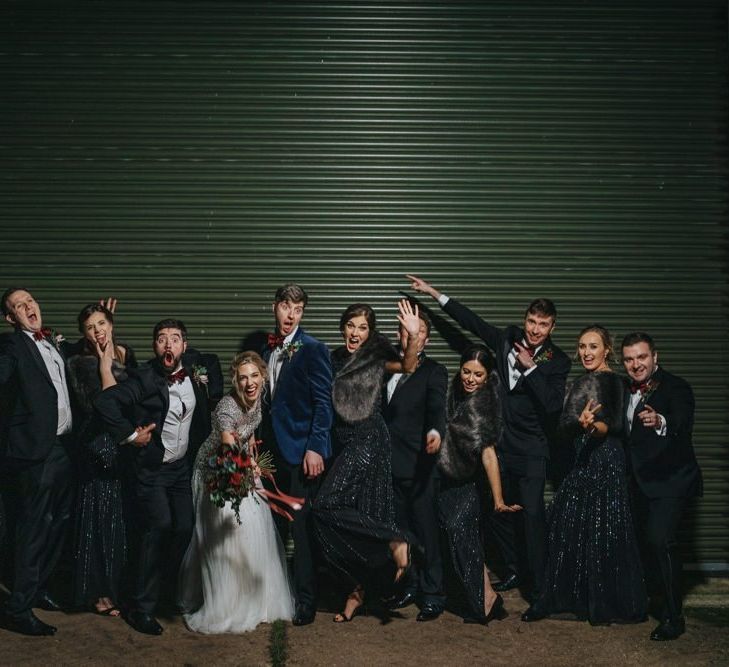 Bride and groom with  groomsmen in black tie and black bridesmaid dresses