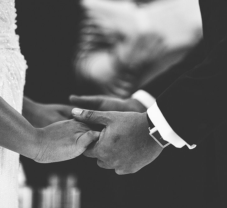 Bride and Groom Holding Hands During The Wedding Ceremony