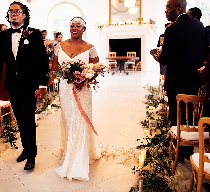 Black Bride in Juliet Cap Veil and Eliza Jane Howell Wedding Dress and Groom in Tuxedo Walking Up The Aisle as Husband and Wife