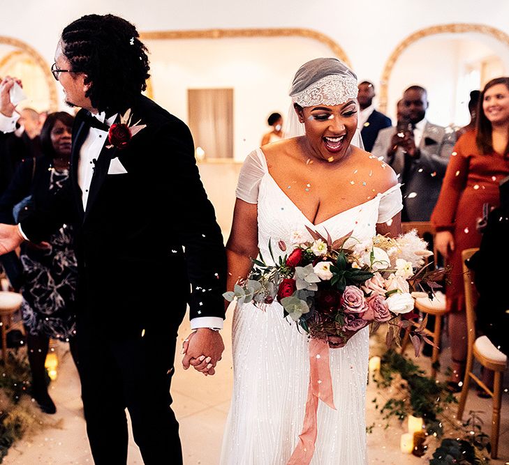 Confetti Moment with Black Bride in Juliet Cap Veil and Eliza Jane Howell Wedding Dress and Groom in Tuxedo