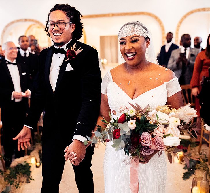 Smiley Confetti Moment with Black Bride in Juliet Cap Veil and Eliza Jane Howell Wedding Dress and Groom in Tuxedo