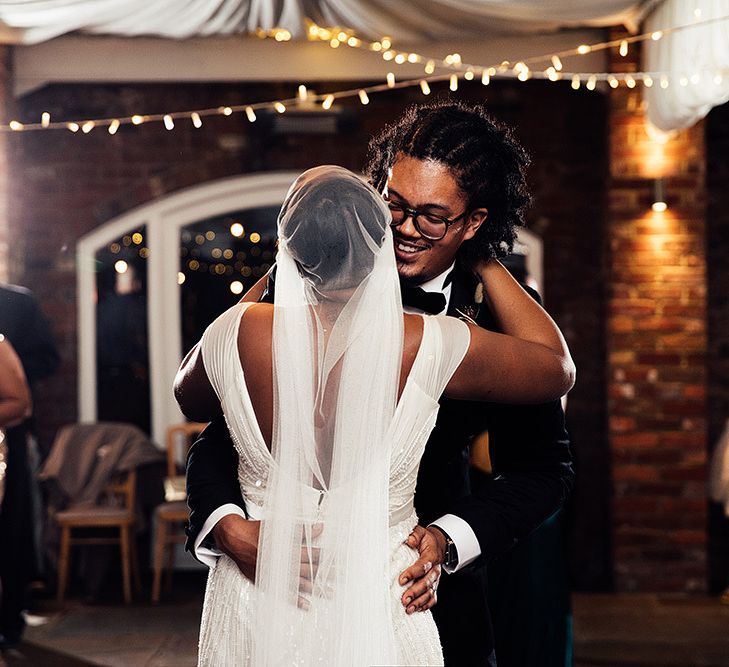 First Dance with Black Bride in Juliet Cap Veil and Eliza Jane Howell Wedding Dress and Groom in Tuxedo and Glasses