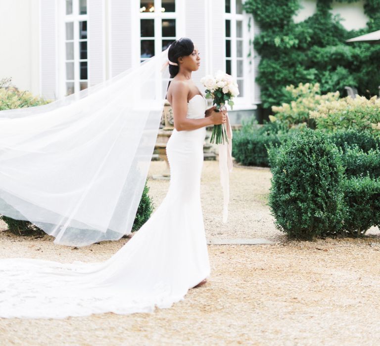 Beautiful bride in strapless Enzoani wedding dress and veil