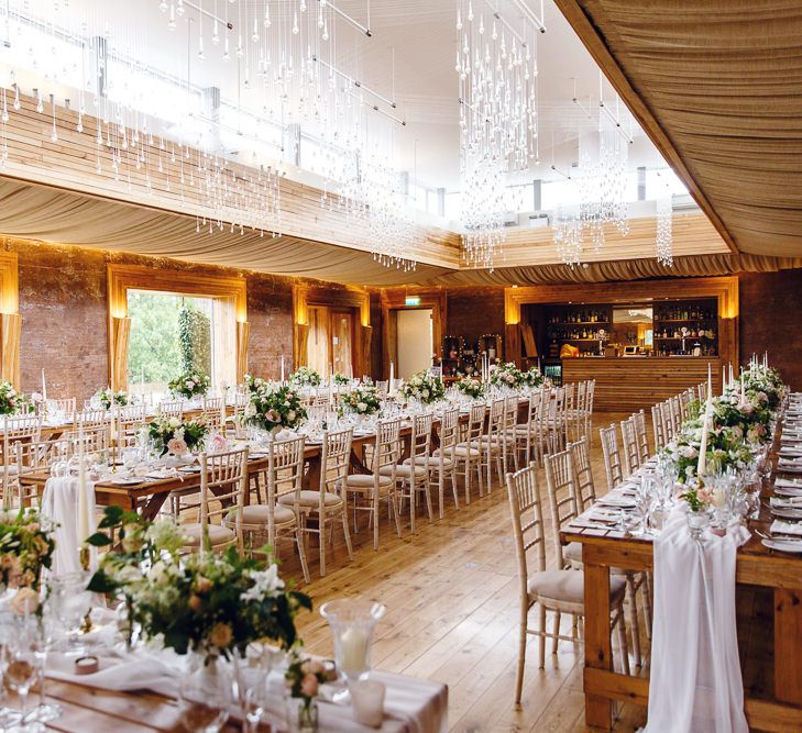 Banquet Tables | Soft White Table Runners | White Tapered Candles | Gold Candlestick Holders | Rose and Peony Centrepieces | Bud Vases | Wedding Reception in The Gillyflower at Elmore Court | Peg Board Table Plan &amp; DIY Sweet Table for an Elmore Court Wedding | Mavric Photography