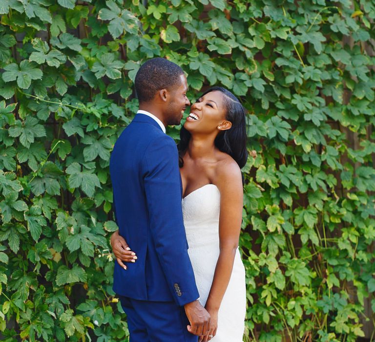 Bride in Lace Fishtail Gown with Strapless Sweetheart Neckline by Suzanne Neville | Groom in Blue Three-Piece Ted Baker Suit with Blush Pink Tie | Peg Board Table Plan &amp; DIY Sweet Table for an Elmore Court Wedding | Mavric Photography