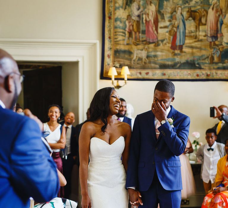 Bride in Lace Fishtail Gown with Strapless Sweetheart Neckline by Suzanne Neville | Groom in Blue Three-Piece Ted Baker Suit with Blush Pink Tie | Peg Board Table Plan &amp; DIY Sweet Table for an Elmore Court Wedding | Mavric Photography