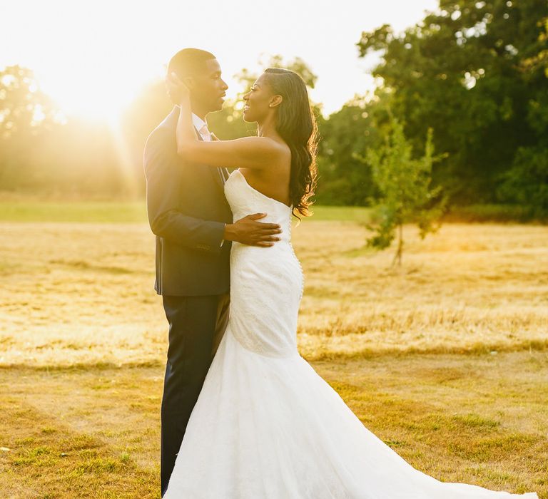 Bride in Lace Fishtail Gown with Strapless Sweetheart Neckline by Suzanne Neville | Groom in Blue Three-Piece Ted Baker Suit with Blush Pink Tie | Peg Board Table Plan &amp; DIY Sweet Table for an Elmore Court Wedding | Mavric Photography