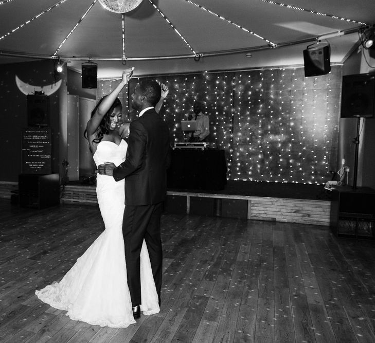 Bride in Lace Fishtail Gown with Strapless Sweetheart Neckline by Suzanne Neville | Groom in Blue Three-Piece Ted Baker Suit with Blush Pink Tie | Glitter Ball | Fairy Light Canopy | First Dance | Peg Board Table Plan &amp; DIY Sweet Table for an Elmore Court Wedding | Mavric Photography