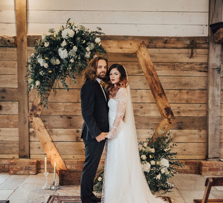 Hexagonal Moon Gate Altar with Persian Rugs | Geometric Wedding Decor &amp; Styling by Locate to Create at The Cherry Barn | Rebecca Carpenter Photography