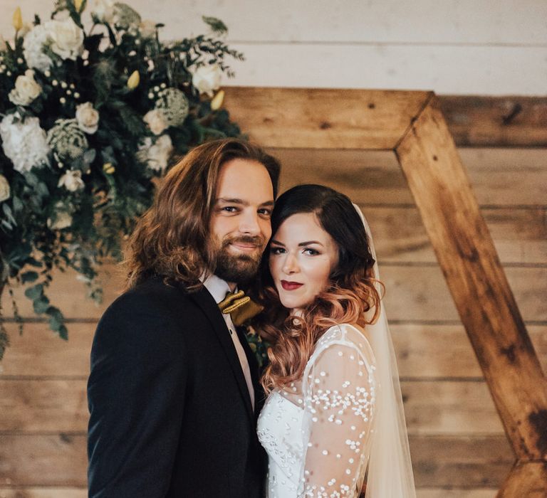 Boho Bride &amp; Long Haired Groom in Front of Hexagonal Moon Gate | Geometric Wedding Decor &amp; Styling by Locate to Create at The Cherry Barn | Rebecca Carpenter Photography