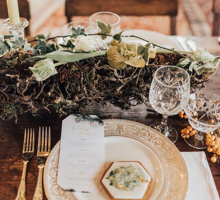 Place Setting with Geometric Biscuit Wedding Favour | Trestle Table Wedding Reception Tables | Fairy Lights | Taper Candles | Vintage Crockery &amp; Cut Glass | Geometric Wedding Decor &amp; Styling by Locate to Create at The Cherry Barn | Rebecca Carpenter Photography