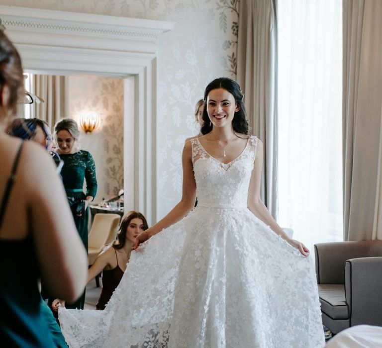 Bride with sweetheart neckline dress with lace overlay with emerald green bridesmaid dresses