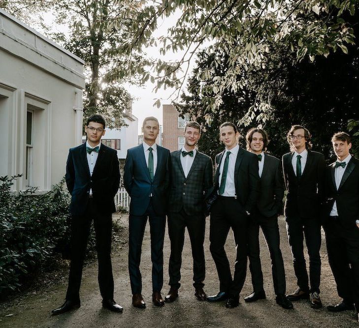 Groomsmen in green ties to match emerald green bridesmaid dresses