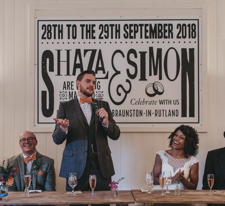 Groom in Grey Check Suit Delivering His Wedding Speech with Top Table Back drop Poster