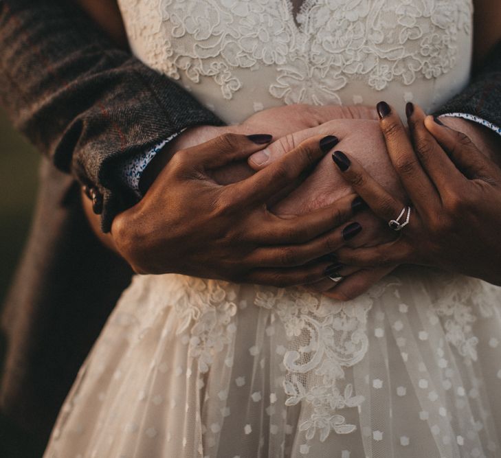 Groom Embracing His Bride in a Polka Dot and Lace Tulle Wedding Dress