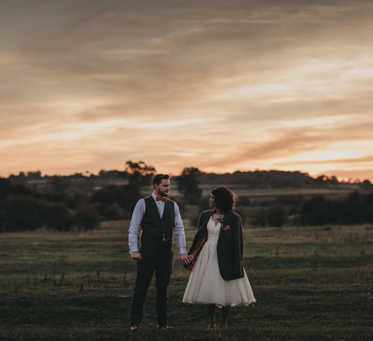 Golden Hour Portrait of Bride in Tea Length Wedding Dres and Groom in Waistcoat