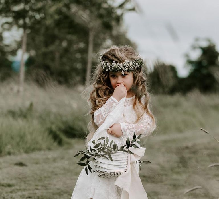 Beautiful flower girl in white dress with flower crown