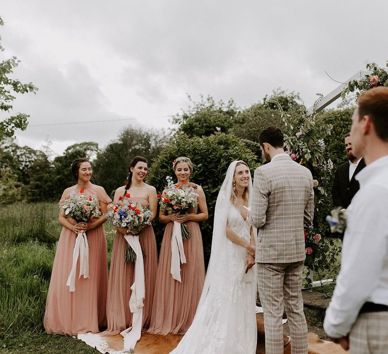 Pink bridesmaid dresses during micro wedding