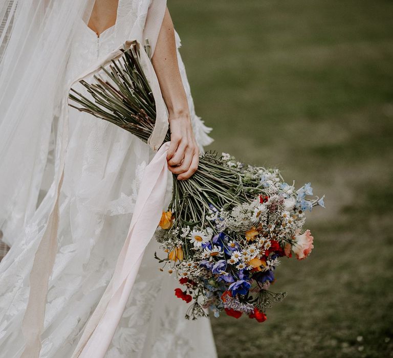 Bride carrying wildflower bouquet for micro wedding