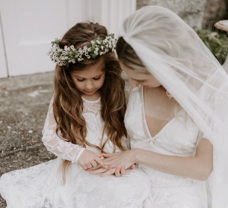 Bride shares a sweet moment with flower girl