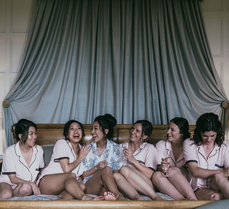 Bridal Party Sitting on the Bed on the Wedding Morning