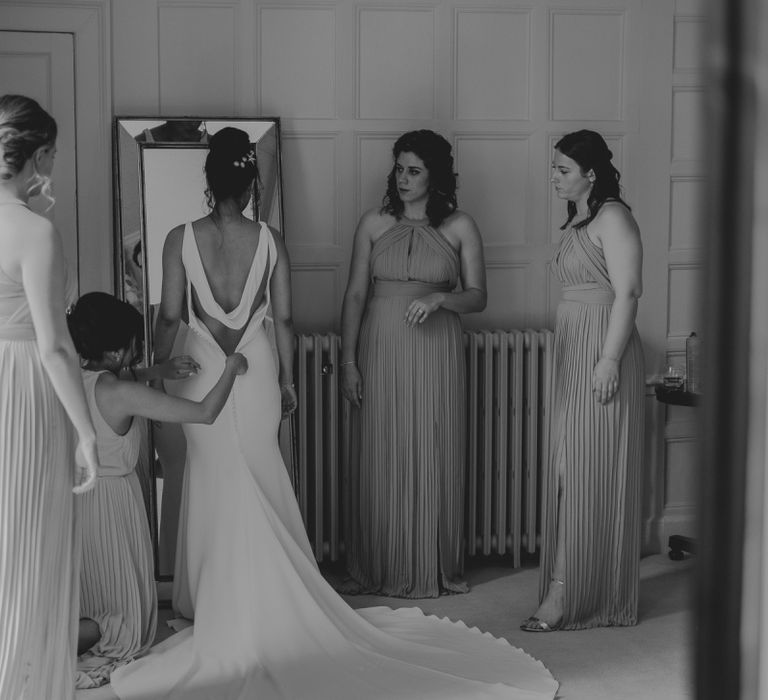 Wedding Morning Bridal Preparations with Bridesmaids Helping the Bride into Her Pronovias Fitted Wedding Dress