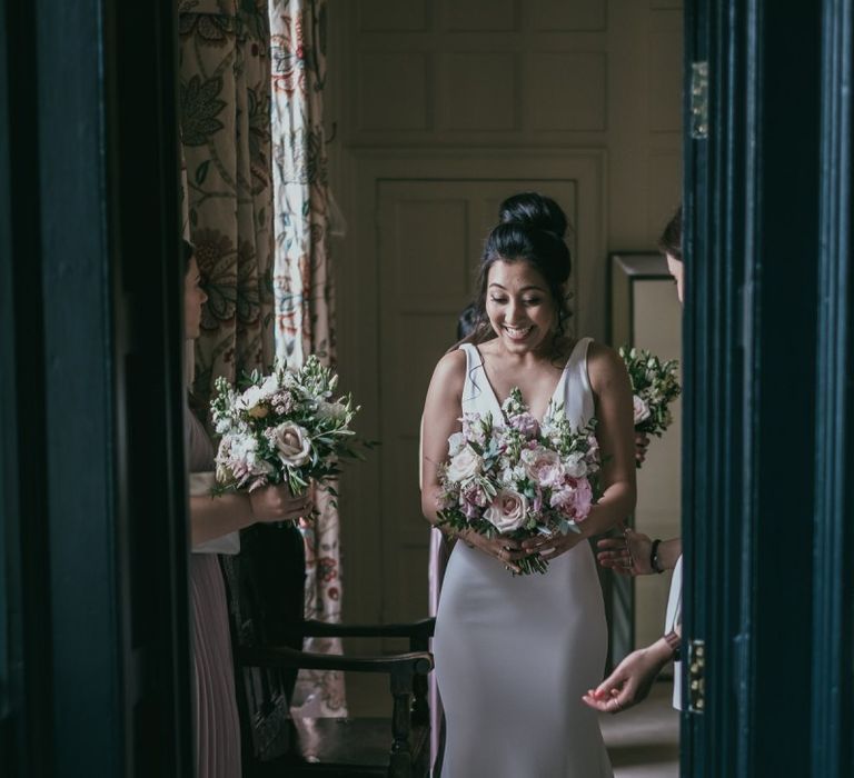 Beautiful Bride in a Pronovias Fitted Wedding Dress Holding a Pink and White Wedding Bouquet