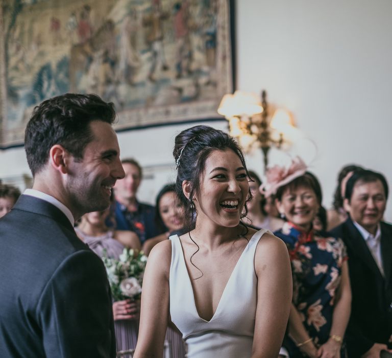 Wedding Ceremony with Bride with High Bun Laughing at the Altar