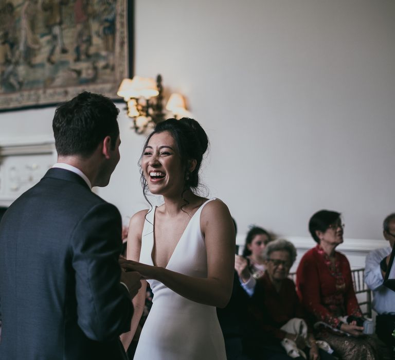 Bride and Groom Holding Hands During the Wedding Ceremony at Elmore Court