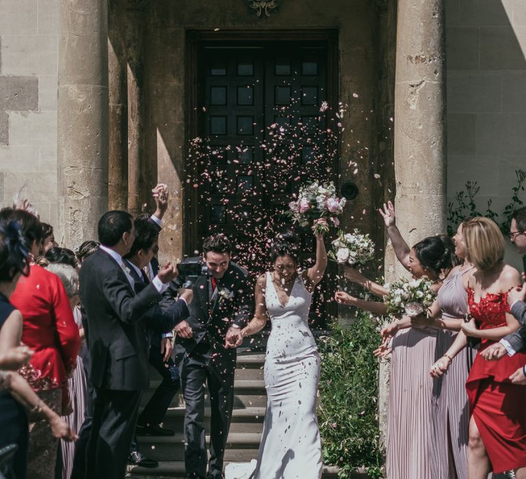 Confetti Moment with Bride in Pronovias Wedding Dress and Groom in Cad &amp; The Dandy Suit